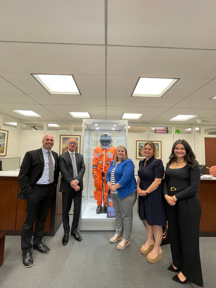 There are five people in front of the camera